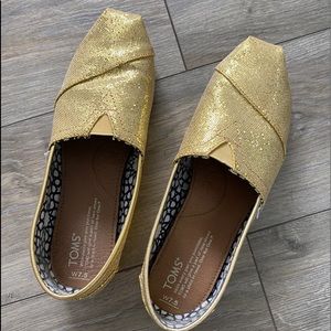 Gold glitter Tom's slip ons